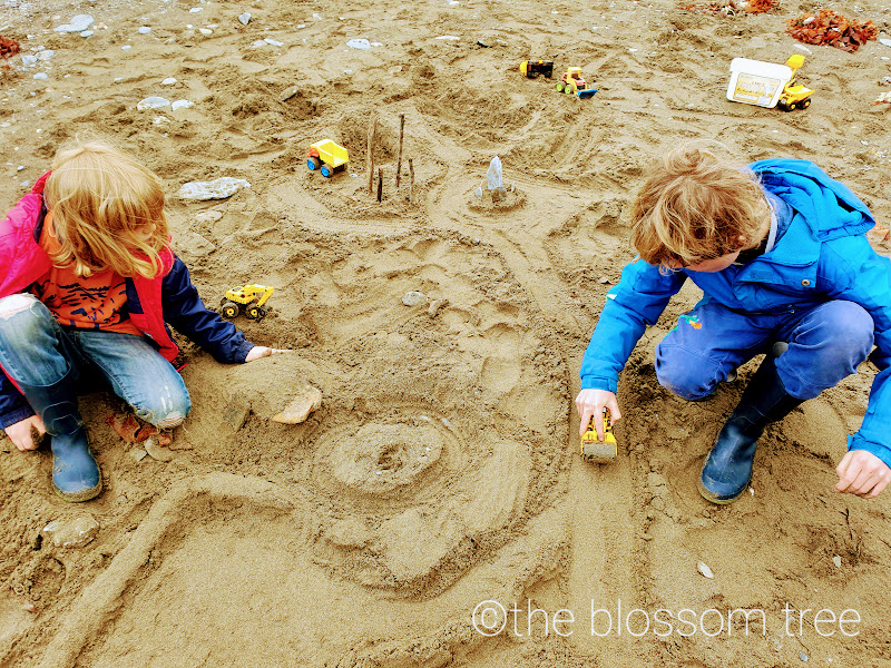 children playing in the sand: Play is vitally important on so many levels, not just to facilitate learning but also on a physical, social, creative and spiritual level.